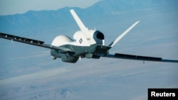 FILE - A U.S. Triton surveillance aircraft is seen during a test flight over Palmdale, California, in this handout photo released by the U.S. Navy May 22, 2013.