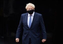 FILE - Britain's Prime Minister Boris Johnson visits the headquarters of Octopus Energy in London, Oct. 5, 2020.