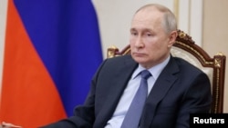 FILE PHOTO: Russian President Putin chairs a meeting on the social and economic development of Crimea and Sevastopol, in Moscow