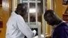 Men buy cinema tickets at the entrance at Cine Burkina during the Panafrican Film and Television Festival (FESPACO) in Ouagadougou, Burkina Faso, March 3, 2017.