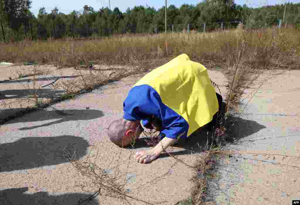 A Ukrainian serviceman reacts after being released from Russian captivity at an undisclosed location near the Ukrainian-Belarusian border, amid the Russian invasion in Ukraine.