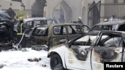 Firemen work at the site where a car exploded near a Shi'ite mosque in Dammam, Saudi Arabia, May 29, 2015. 