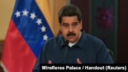 FILE - Venezuela's President Nicolas Maduro speaks during a meeting with ministers at the Miraflores Palace in Caracas, Venezuela, Aug. 13, 2018.