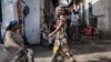 FILE - People walk through the Birere market in Goma, March 26, 2015. 