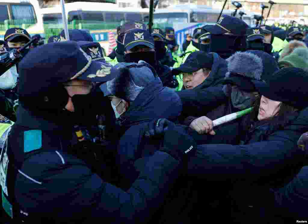 Impeached South Korean President Yoon Suk Yeol's supporters scuffle with police officers as authorities seek to execute an arrest warrant, in Seoul.