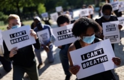 FILE - People protest against the death of George Floyd who died in police custody in Minneapolis, next to the U.S. embassy in Paris, France, June 1, 2020.