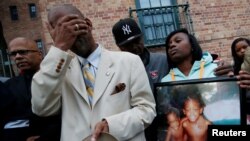 Mourners grieve at a vigil in honor of Edward and Edwin Bryant, twin brothers who at age 17 were shot and killed in Chicago, Illinois, Oct. 31, 2016.