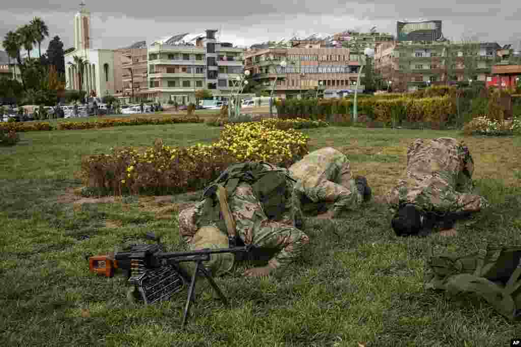 Members of the armed forces and former rebels, who overthrew Bashar al-Assad's government and now serve in the new Syrian government, pray before a military parade in downtown Damascus, Syria.