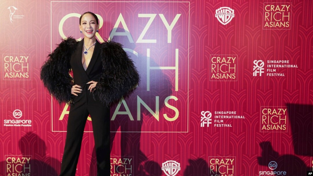 Actress Fiona Xie poses for photographers as she arrives for the red carpet screening of the movie "Crazy Rich Asians," Aug. 21, 2018, in Singapore.