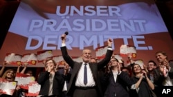 Presidential candidate Alexander Van der Bellen celebrates his victory in Sunday's presidential election with supporters in Austria's capital Vienna, Dec. 4, 2016. Van der Bellen beat his far-right opponent Norbert Hofer by a seven percent margin. The sign above reads "Our President of the Center."