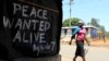 A woman walks past a message of peace in Kibera slum in the capital Nairobi, February 28, 2013.