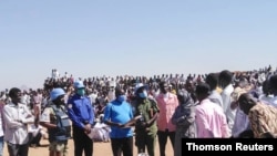 Peacekeepers from the United Nations Hybrid Operation receive a petition from protesters in Darfur, Jan. 13, 2021.