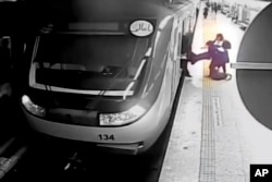 FILE - In this image from surveillance video aired by Iranian state television, women pull 16-year-old Armita Geravand from a train car on the Tehran Metro in Tehran, Iran, on Oct. 1, 2023.