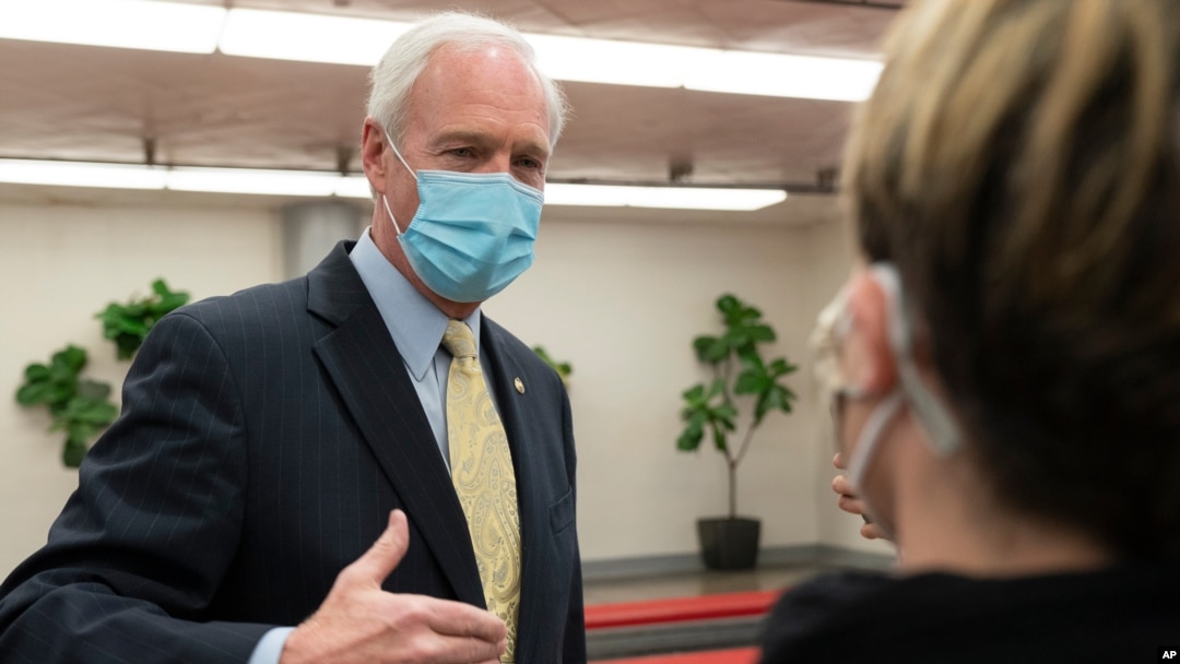 Sen. Ron Johnson, R-Wis., answers reporters after leaving the Senate floor, Jan. 26, 2021, on Capitol Hill in Washington.