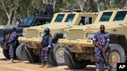 FILE - African Union (AU) soldiers stand with their armored vehicles near a checkpoint on the eve of presidential elections in Mogadishu, Somalia, Feb. 7, 2017. 
