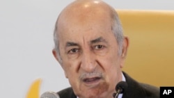 FILE - Newly elected Algerian President Abdelmadjid Tebboune speaks during a press conference, Dec.13, 2019, in Algiers. 