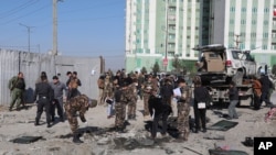 Afghan security personnel investigate at the site of a bomb attack in Kabul, Afghanistan, Dec. 15, 2020. A bombing and a shooting attack on Tuesday killed several people, including Kabul's deputy governor. 