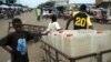 FILE - A boy sells jerrycans at a market area in the Liberian capital of Monrovia.