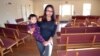 FILE - Ingrid Encalada Latorre walks with her year-old son, Anibal, where she is taking sanctuary at a Denver Quaker center, the Mountain View Friends Meeting, a small, two-story brick structure just blocks from the University of Denver, in Denver. 