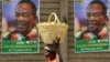 FILE - A street vendor carries fruit outside an election rally of President Emmerson Mnangagwa's ruling ZANU-PF party in Mutare, Zimbabwe, May 19, 2018. 