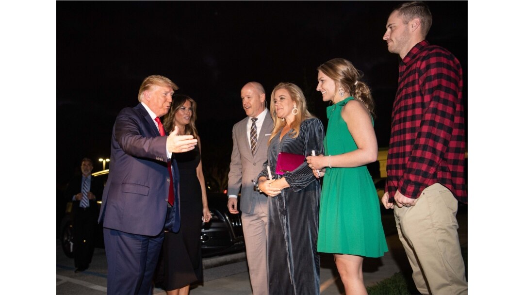 President Donald Trump. left, and first lady Melania Trump greet lead pastor Jimmy Scroggins, his wife, Kristin, and their son and daughter-in-law, James, right, and Reilly as they arrive at the Family Church Downtown for a Christmas Eve service.