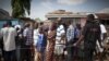 FILE - People wait in line to vote at a polling station in Accra, Ghana, Dec. 8, 2012.
