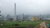 FILE - Farmers work their fields outside the Sungri Chemical Factory, an oil refinery in the Rason Special Economic Zone near North Korea's Russian and Chinese borders, July 23, 2016. 