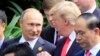 FILE - Russian President Vladimir Putin and U.S. President Donald Trump talk as they arrive for the family photo session during the APEC summit in Danang, Vietnam, Nov. 11, 2017.