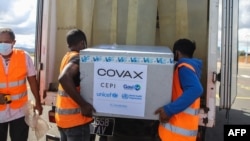 FILE - Workers load boxes of Oxford/AstraZeneca COVID-19 vaccines, part of the Covax program, into a truck after they arrived by plane at the Ivato International Airport in Antananarivo, Madagascar, May 8, 2021.