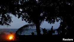 FILE - Migrants camp after crossing through the Colombian jungle on their way toward the United States, Nov. 26, 2015.