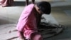 A resident sits on the floor in the women’s ward of Thane Mental Hospital, a 1,857-bed facility in the suburbs of Mumbai. © 2013 Shantha Rau Barriga/Human Rights Watch 