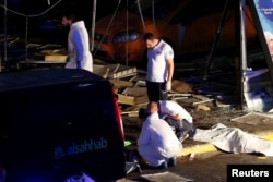 Forensic experts work outside Turkey's largest airport, Istanbul Ataturk, following a blast in Turkey, June 28, 2016.