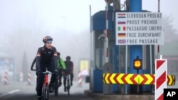 Cyclists cross the Rupa border between Croatia and Slovenia for the first time without any interruptions, Croatia, Sunday, Jan. 1, 2023. 