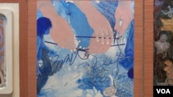 The panel of Kyujin Lee shows hands trying to knit an unruly thread. This, she says, shows her own separation from South Korea and how her life has become knitted into the US. (Jsoh/VOA)