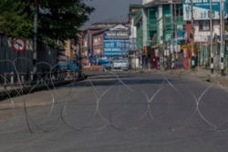 A barbwire blocks a deserted street on the first anniversary of India’s decision to revoke the disputed region’s semi-autonomy, in Srinagar, Indian-controlled Kashmir, Aug. 5, 2020.