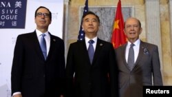 U.S. Treasury Secretary Steve Mnuchin (L), Commerce Secretary Wilbur Ross (R) and China's Vice Premier Wang Yang pose for a family photo before the U.S. - China Comprehensive Economic Dialogue to discuss bilateral economic and trade issues.