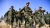 FILE - Afghan National Army soldiers march during a ceremony at a military base in the Guzara district of Herat province, Oct. 11, 2020. 