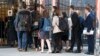 FILE - A group of students enters the building that houses the Russian Mission to the United Nations in New York for a tour, March 26, 2018. Russia is urging about 60,000 of its citizens studying abroad to return home.