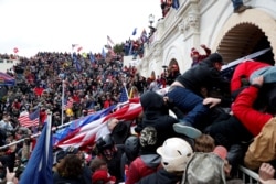 FILE - Supporters of then-President Donald Trump storm the U.S. Capitol to contest the certification of the 2020 presidential election results by Congress, in Washington, Jan. 6, 2021.
