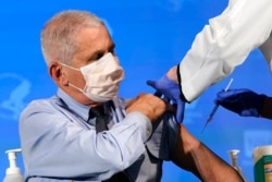 FILE - Dr. Anthony Fauci, director of the National Institute of Allergy and Infectious Diseases, prepares to receive his first dose of the COVID-19 vaccine at the National Institutes of Health, in Bethesda, Md., Dec. 22, 2020.