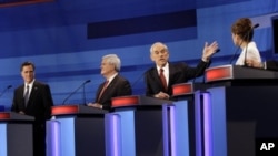 Republican presidential candidates from left, former Massachusetts Gov. Mitt Romney, former House Speaker Newt Gingrich, Rep. Ron Paul, R-Texas, and Rep. Michele Bachmann, R-Minn., participate in a Republican presidential debate in Sioux City, Iowa, Dec.
