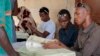 FILE - A new Burundi electoral schedule has been proposed for a July 15 presidential election. Here, election workers distribute voter cards in the capital, Bujumbura, June 4, 2015. 