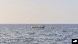 In this photo released by the U.S. Navy, sailors intercept a dhow in the Gulf of Oman on Nov. 8, 2022.