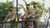 FILE - Incoming commander, Gen. Paul J. LaCamera, right, and outgoing commander, Gen. Robert B. Abrams, center, inspect the troops during a change-of-command ceremony in Pyeongtaek, South Korea, July 2, 2021.