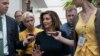 Speaker of the House Nancy Pelosi is surrounded by reporters as she arrives to meet with her caucus at the Capitol in Washington.
