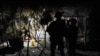 FILE - A U.S. Army officer, accompanied by an interpreter, talks to an Afghan resident while on a night patrol in Kandalay village, Afghanistan, Aug. 4, 2011.
