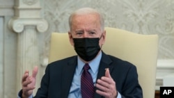 FILE - President Joe Biden speaks in the Oval Office of the White House, in Washington, Feb. 5, 2021.