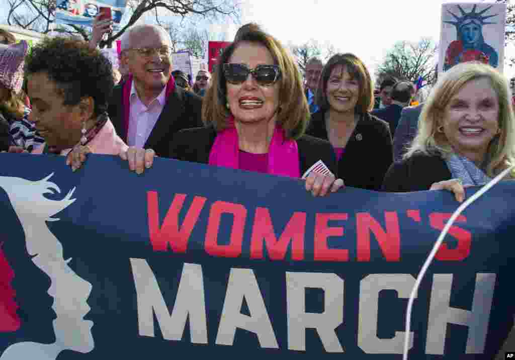 House Minority Leader Nancy Pelosi, D-Calif., center, Rep. Susan Davis, D-Calif, background center right, and Rep. Carolyn Maloney, D-N.Y., right, participate in the Women's March walk to the White House in Washington, Jan. 20, 2018. 