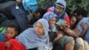 Police in Ventimiglia, Italy drag Eritrean and Sudanese refugees from encampments near the French border last June. Paris officials refused to let them cross into France.