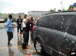 FILE - Somali-Americans in Minnesota participate in a car-wash fundraiser to help Somali drought victims in 2012.